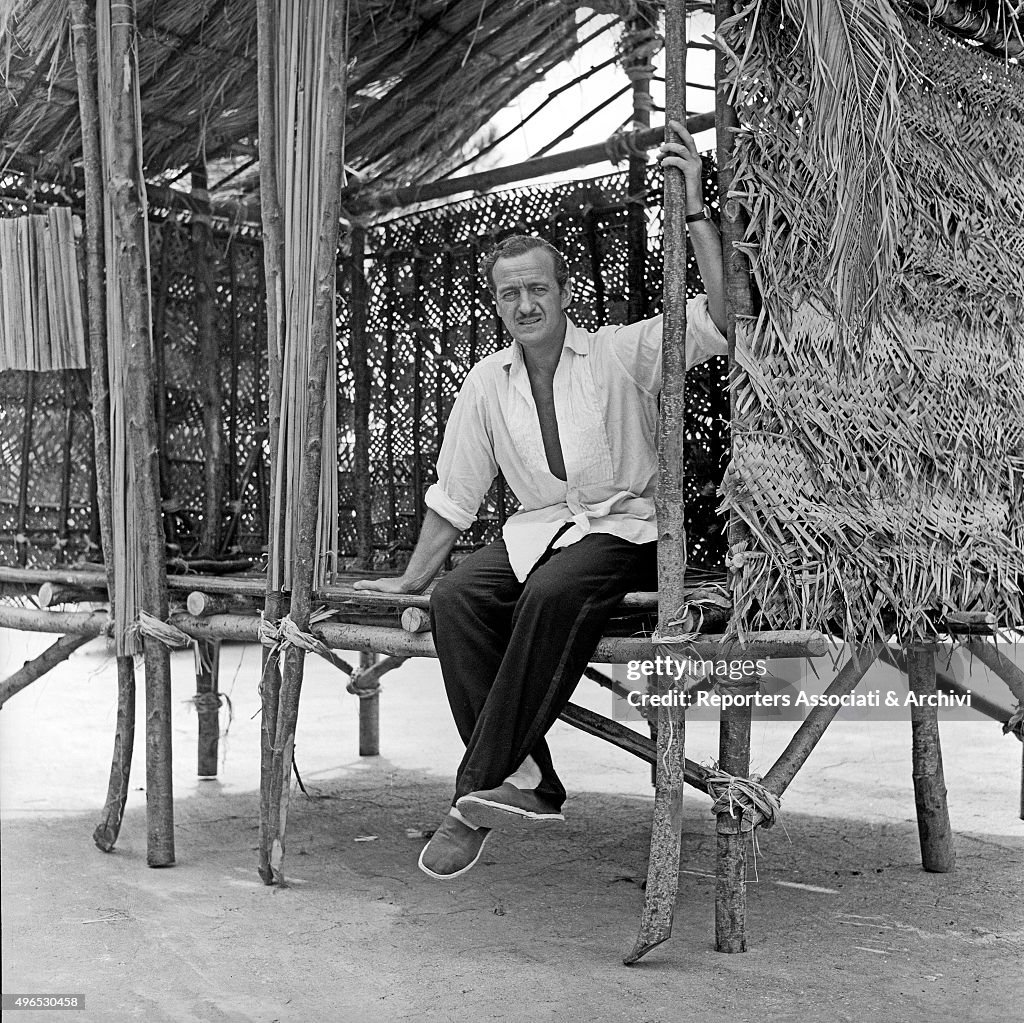 David Niven in a hut in Cinecittà