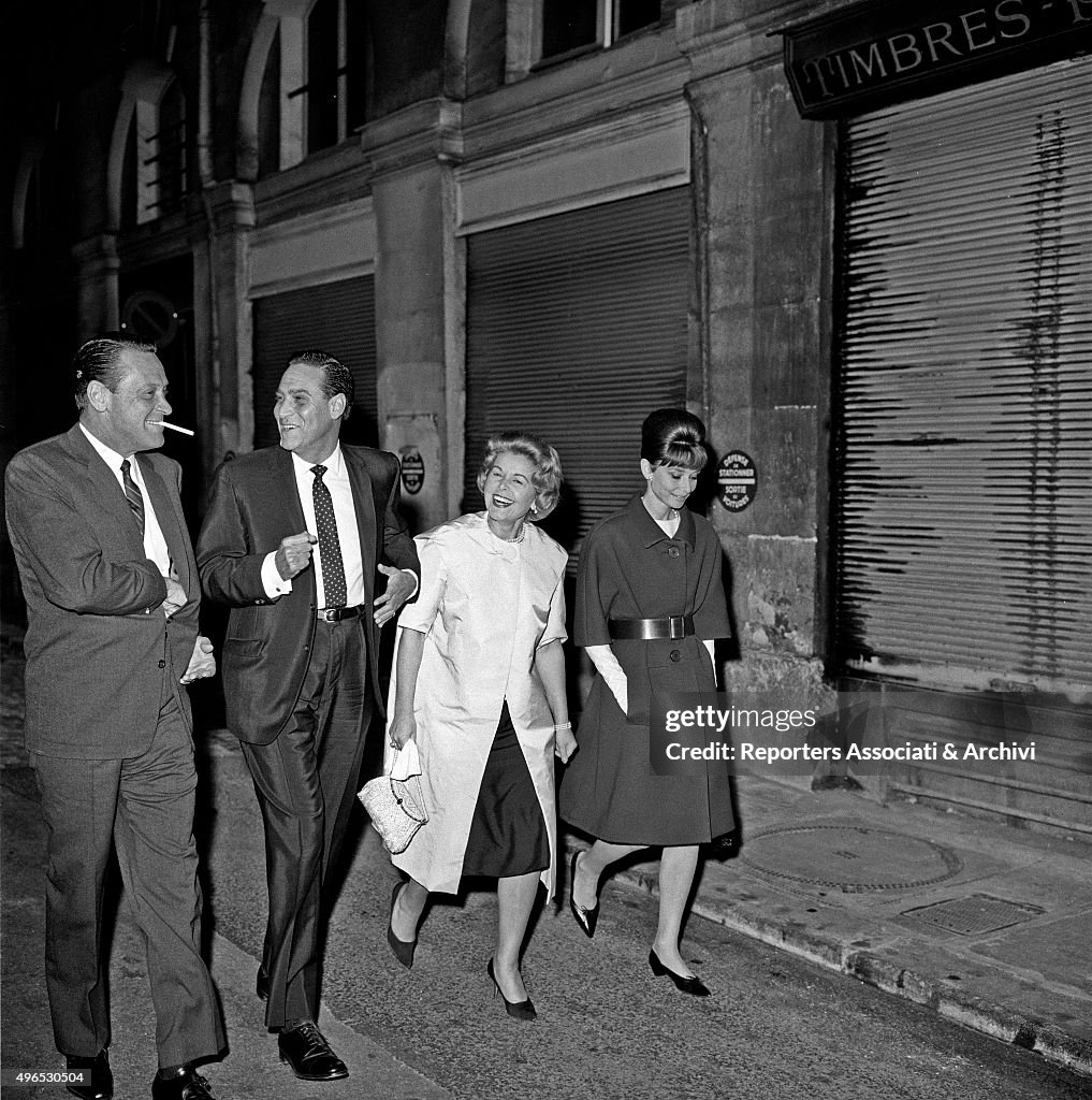 Audrey Hepburn, William Holden and Curd Jurgens walking in Paris