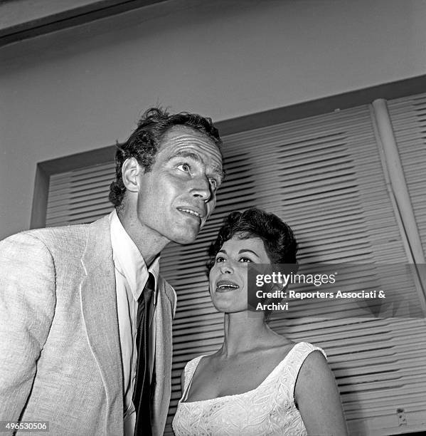 American actor Charlton Heston listening to his wife, American actress Lydia Clarke, during the cocktail party in the studios of Cinecittà before...