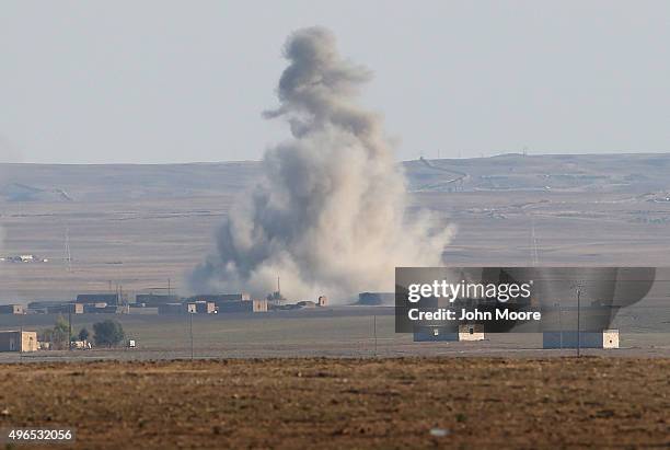 An airstrike by a U.S. Led coaltion warplane explodes on an ISIL position on November 10, 2015 near the town of Hole, Rojava, Syria. Troops from the...