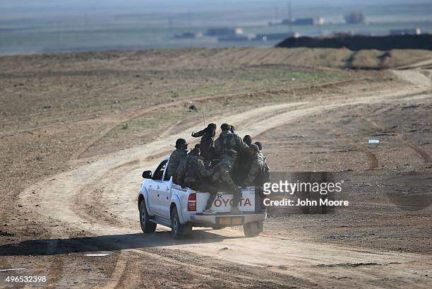 Troops from the Syrian Democratic Forces head to the frontline on November 10, 2015 near the ISIL-held town of Hole in the autonomous region of...