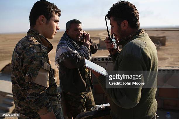 Kurdish commanders from the Syrian Democratic Forces coordinate frontline troop movements with the help of a tablet on November 10, 2015 near the...