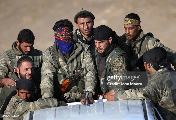 Troops from the Syrian Democratic Forces head towards the frontline on November 9, 2015 near the ISIL-held town of Hole in the autonomous region of...