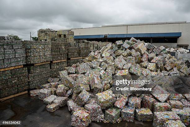 Bales of crushed aluminium cans sit outside a warehouse after being unloaded from a truck at the Latasa Reciclagem SA collection center in...