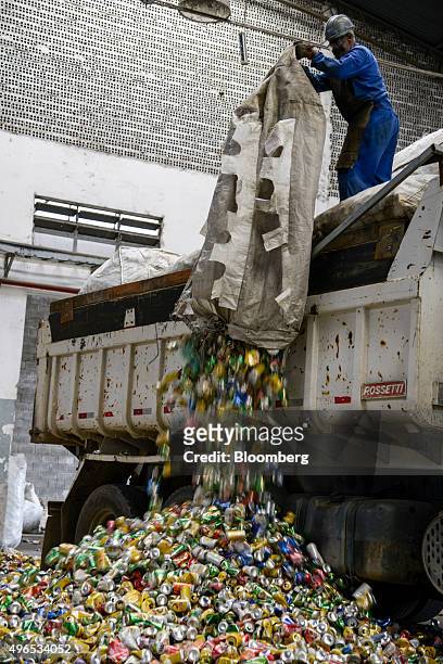 Worker unloads aluminium cans from a truck at the Latasa Reciclagem SA collection center in Pindamonhangaba, Brazil, on Wednesday, Nov. 4, 2015....