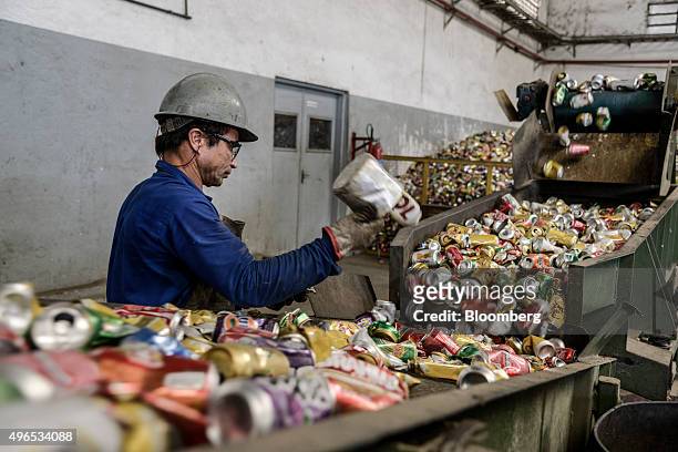 Worker checks aluminium cans headed for recycling at the Latasa Reciclagem SA collection center in Pindamonhangaba, Brazil, on Wednesday, Nov. 4,...