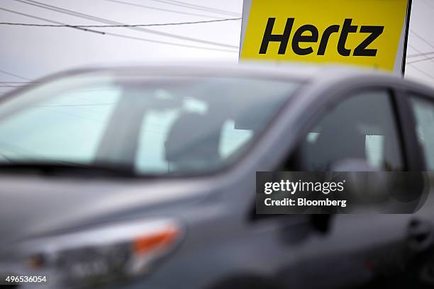 Signage is displayed outside of a Hertz Global Holdings Inc. Rental car and sales location in Louisville, Kentucky, U.S., on Friday, Nov. 6, 2015....