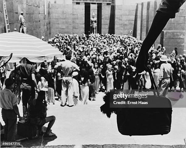 Setting up a crowd scene on the set of the film 'Land of the Pharaohs' during location shooting in Egypt, circa 1955.