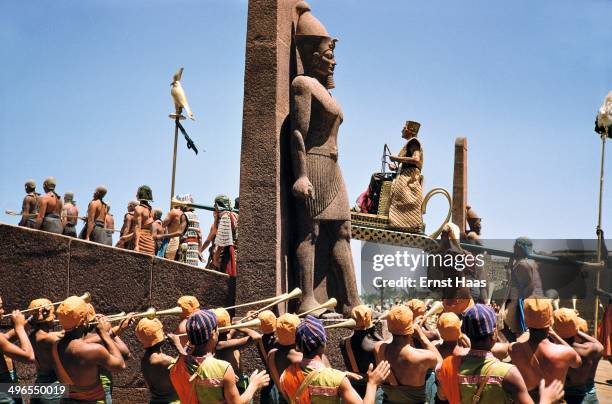 Actor Jack Hawkins as Pharaoh Khufu, entering the city amidst pomp and splendour, during the filming of 'Land of the Pharaohs', circa 1955.