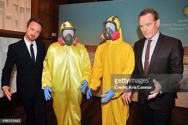 Actors Aaron Paul and Bryan Cranston pose with their Tyvek suits during a donation ceremony of artifacts from AMC's "Breaking Bad" show at...