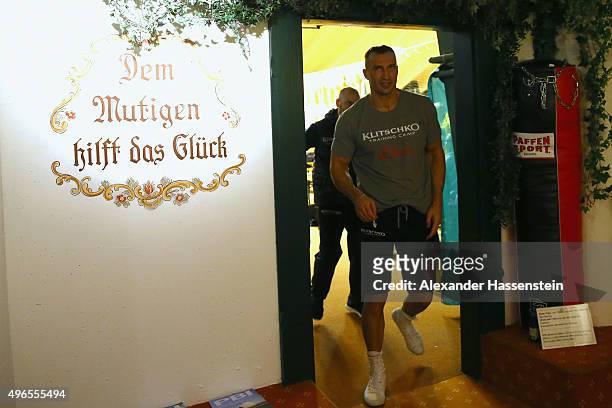 Wladimir Klitschko passes a slogan written on a wall, translated as "the braveheart helps the good luck", as he arrives for a training session at...