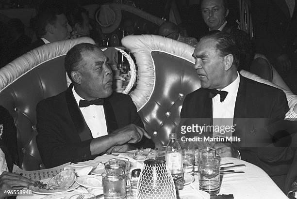 Boxers Joe Louis and Max Schmeling enjoy a dinner together in 1971 in Los Angeles, California.
