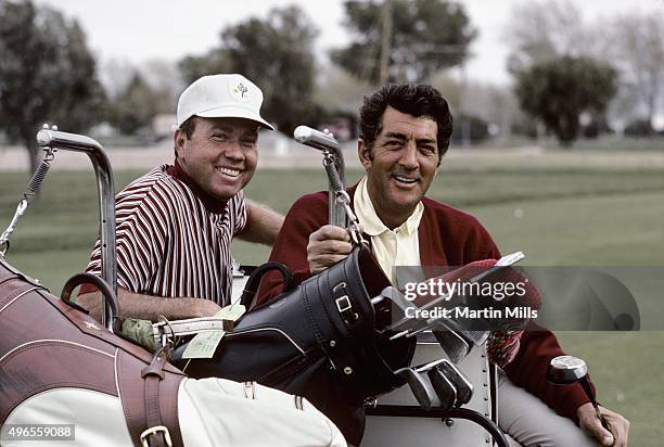 Entertainer Dean Martin plays golf with singer Don Cherry in 1967.