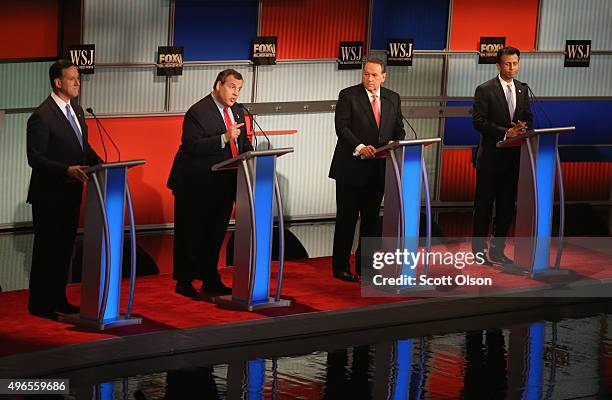 Presidential candidate New Jersey Gov. Chris Christie speaks while Rick Santorum, Mike Huckabee, and Louisiana Gov. Bobby Jindal look on during the...