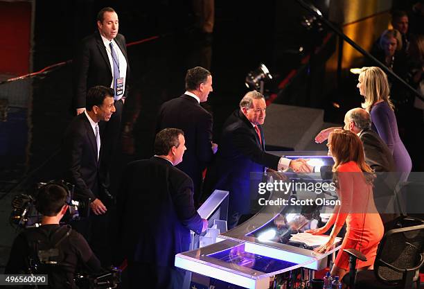 Presidential candidate Mike Huckabee shakes the hands of debate moderators Trish Regan, Gerald Sieb, and Sandra Smith after the Republican...