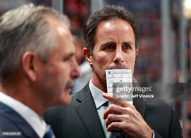 Assistant coach Doug Lidster of the Vancouver Canucks looks on from the bench during their NHL game against the Montreal Canadiens at Rogers Arena...