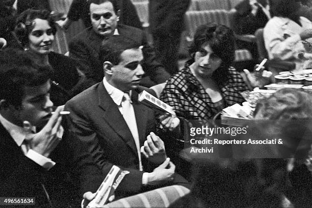 Italian actress Anna Magnani, sitting in the stalls at Sistina theatre beside her son Luca Magnani for Italian-born French singer Yves Montand 's...