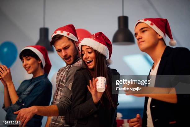 young business people celebrating new year in their office. - christmas office party stock pictures, royalty-free photos & images