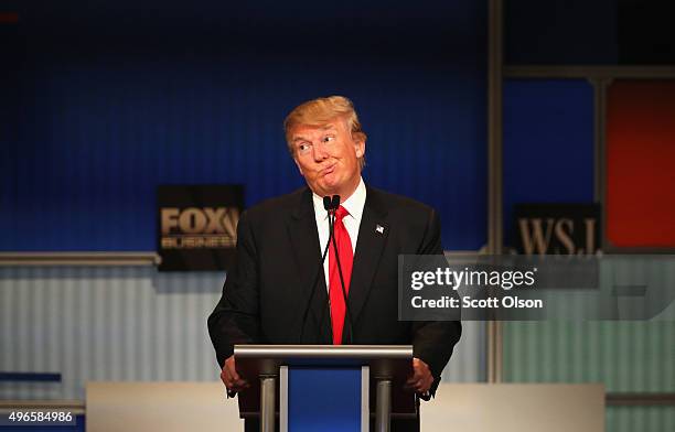 Presidential candidate Donald Trump gestures after Carly Fiorina says she met with Russian President Putin at a one on one meeting, during the...