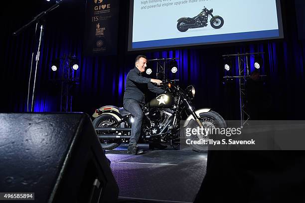 Musician Bruce Springsteen participates in an auction on stage at the New York Comedy Festival and the Bob Woodruff Foundation's 9th Annual Stand Up...