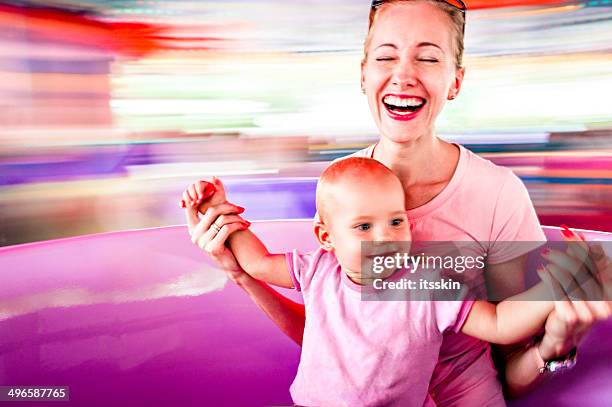 mother and daughter in amusement park - joy ride stock pictures, royalty-free photos & images