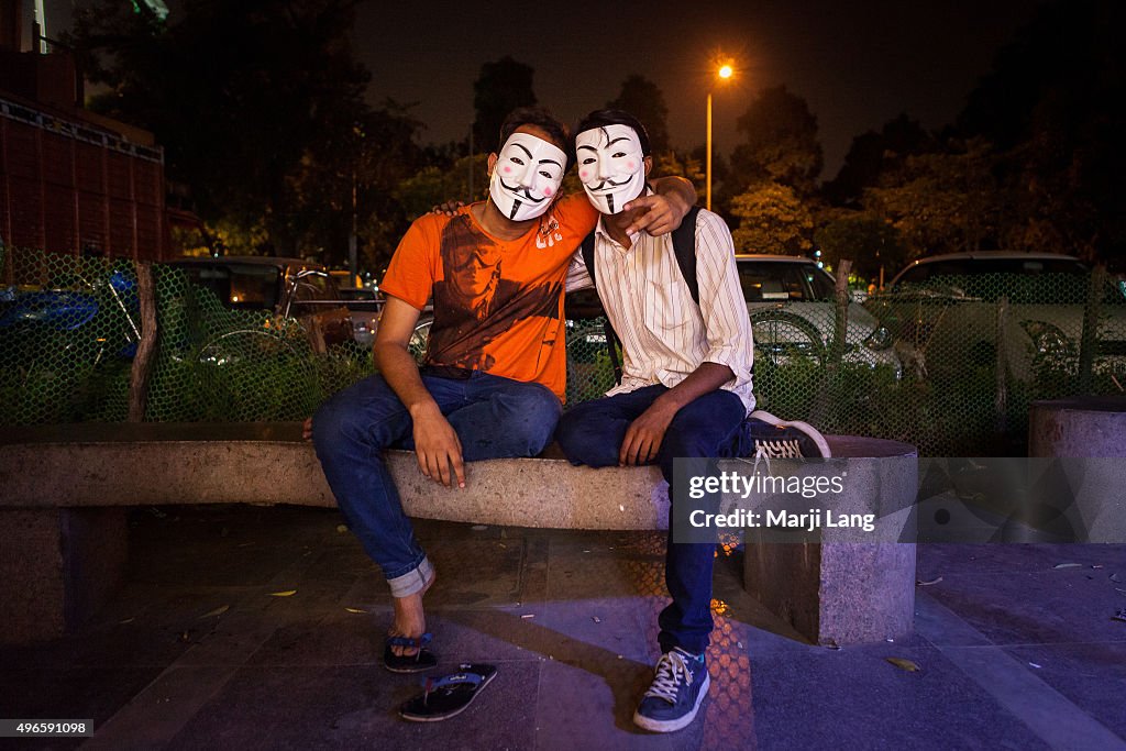 Two young men wearing the Guy Fawkes mask, symbol of the...
