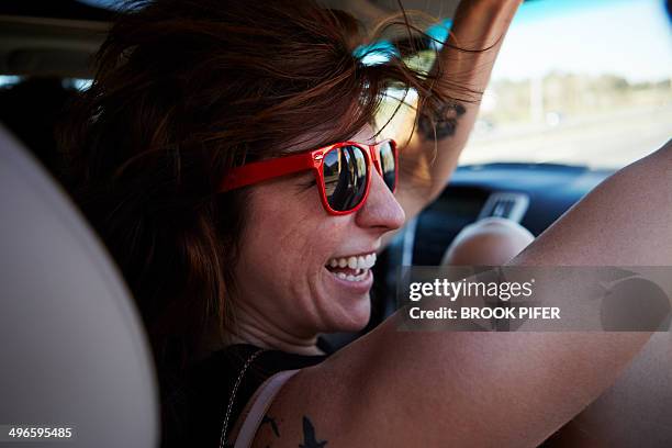 young woman riding in car - cool cars foto e immagini stock