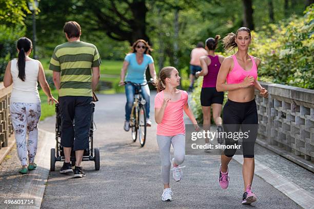 people in park - jogging stroller stockfoto's en -beelden