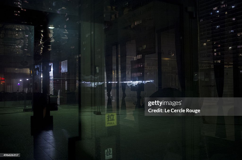 CITY REFLECTION IN A DARK WINDOW AT NIGHT