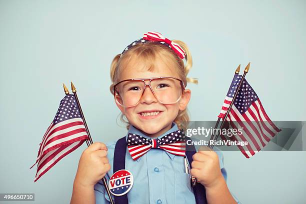 young american girl holding flags on election day - kid president stock pictures, royalty-free photos & images