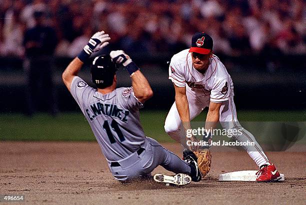 Omar Vizquel of the Cleveland Indians moves to tag Edgar Martinez of the Seattle Mariners as he slides into second base during the ALCS game at...