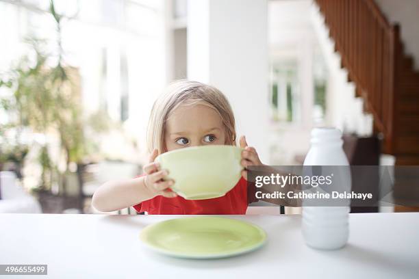 a 3 years old girl taking her breakfast - 2 3 years stockfoto's en -beelden