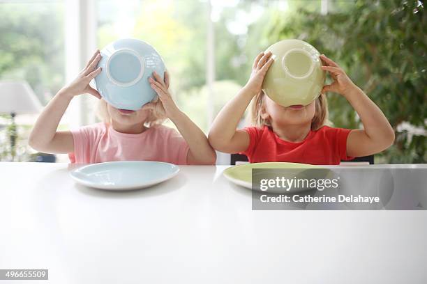 two 3 years old twins girls taking their breakfast - colazione bambini foto e immagini stock