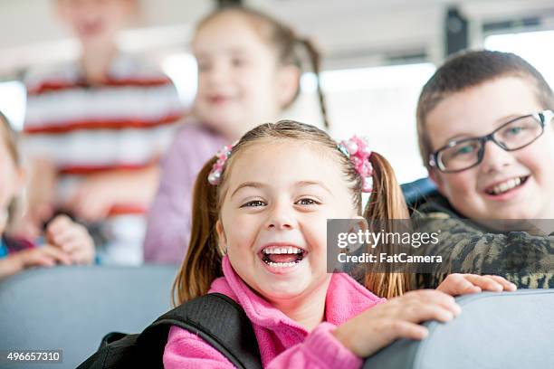 kids happily on the bus - kids sitting together in bus stock pictures, royalty-free photos & images