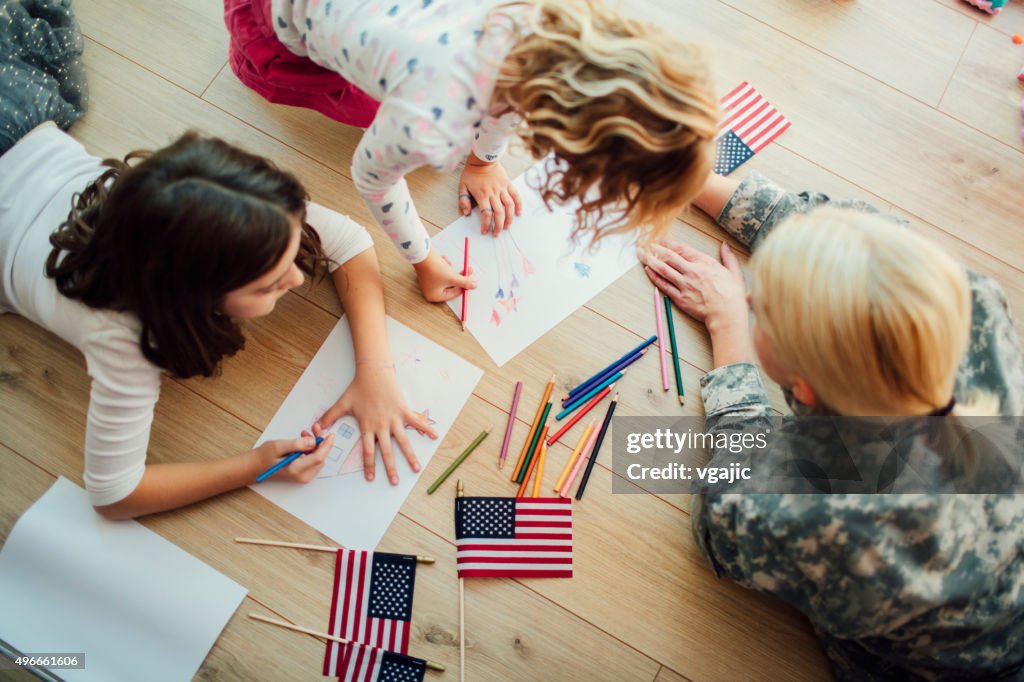Military Mom Coloring With Her Kids.