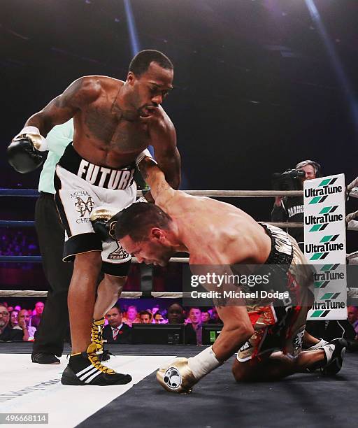 Anthony Mundine of Australia is knocked down by Charles Hatley of the USA at The Melbourne Convention and Exhibition Centre on November 11, 2015 in...