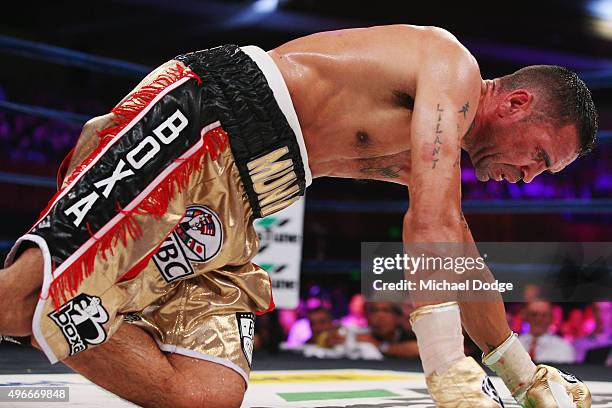 Anthony Mundine of Australia is knocked down by Charles Hatley of the USA at The Melbourne Convention and Exhibition Centre on November 11, 2015 in...