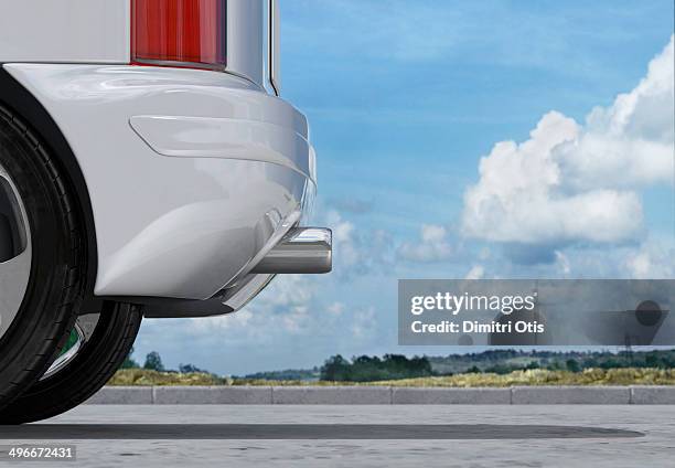 rear of car, exhaust pipe in front of cloudy sky - abgase stock-fotos und bilder