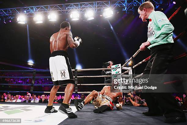 Anthony Mundine of Australia is knocked down by Charles Hatley of the USA at The Melbourne Convention and Exhibition Centre on November 11, 2015 in...