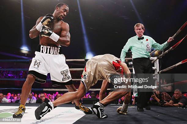 Anthony Mundine of Australia is knocked down by Charles Hatley of the USA at The Melbourne Convention and Exhibition Centre on November 11, 2015 in...