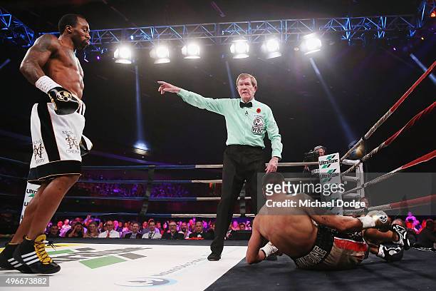 Anthony Mundine of Australia is knocked down by Charles Hatley of the USA at The Melbourne Convention and Exhibition Centre on November 11, 2015 in...