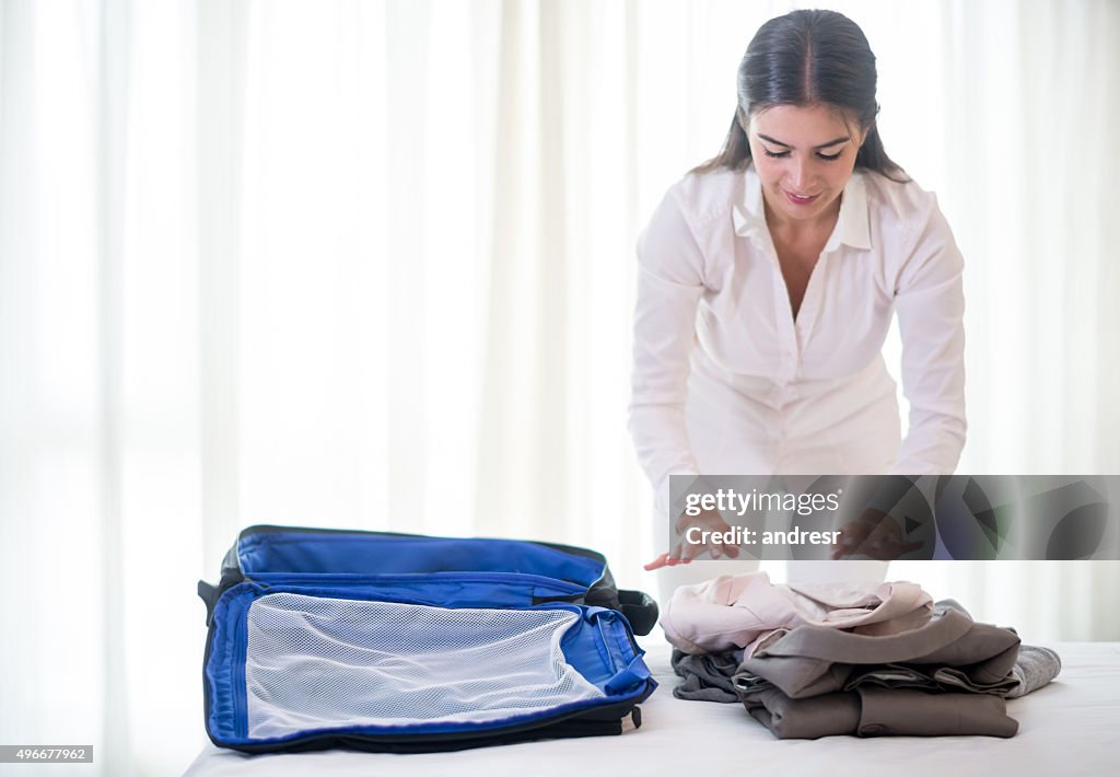 Woman traveling and packing her bag