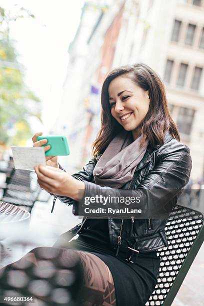 new york woman depositing check remotely - cheque deposit stock pictures, royalty-free photos & images