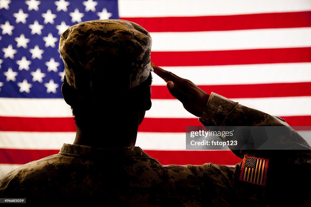 Silhouette of soldier saluting the American flag