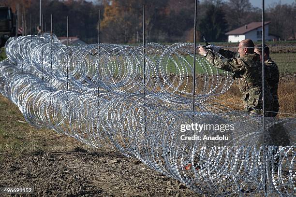 Members of the Slovenia Defence Force install fences on the Slovenian-Croatian border to prevent refugees to enter Europe in Brezice, Slovenia on...