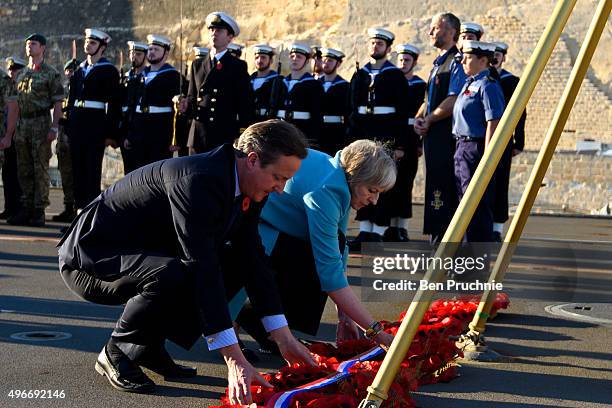 British Prime Minister David Cameron and Home Secretary Theresa May lay a wreath during a remembrance service on HMS Bulwark during the Valletta...