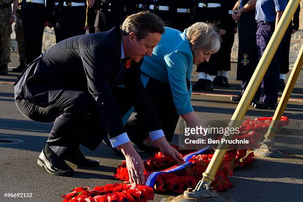 British Prime Minister David Cameron and Home Secretary Theresa May lay a wreath during a remembrance service on HMS Bulwark during the Valletta...