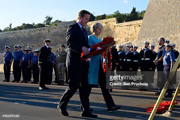 British Prime Minister David Cameron and Home Secretary Theresa May lay a wreath during a remembrance service on HMS Bulwark during the Valletta...