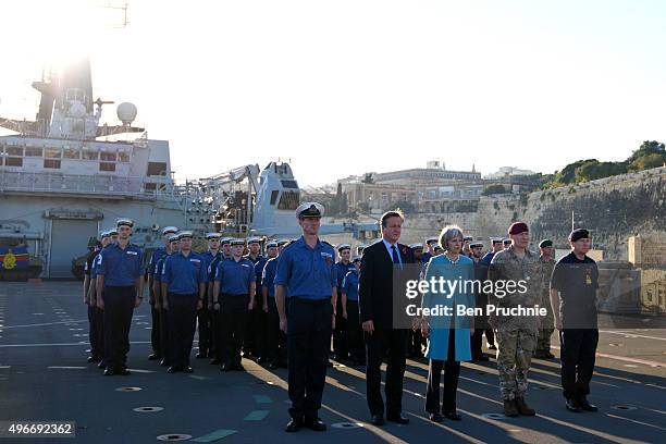 British Prime Minister David Cameron and Home Secretary Theresa May attend a remembrance service on HMS Bulwark during the Valletta Summit on...