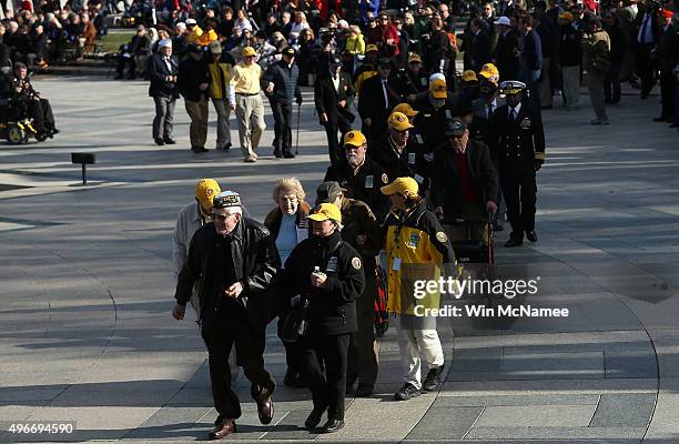 Veterans walk to a wreath laying ceremony while attending a Veterans Day ceremony at the National World War II Memorial November 11, 2015 in...
